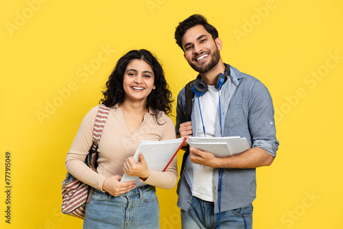 Students With Books And Backpack Standing Against Yellow Background
