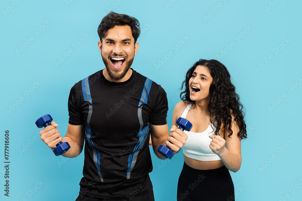 Fitness Couple Working Out Together With Dumbbells On Blue Background, Active Lifestyle, Healthy Living Fitness Couple Working Out Together With Dumbbells On Blue Background, Active Lifestyle, Healthy Living