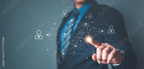future, global, manager, communication, strategy, team, social, touch, information, connect. A man in a suit is pointing at a network of people on a computer screen. Concept of interconnectedness.