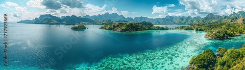 Stunning aerial shot of a lush tropical archipelago with clear turquoise waters surrounded by mountains.