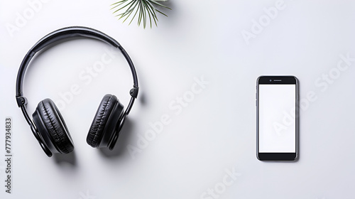 Smartphone with blank screen and headphones on white background, Top view of headphones and smartphone are placed on the wooden table with space for text 