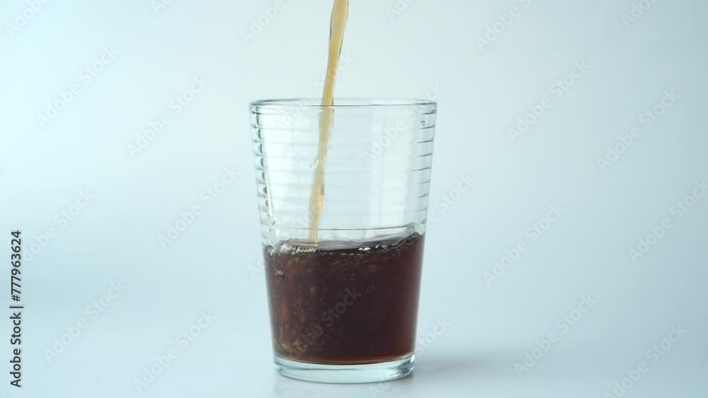 slow motion of pouring soft drinks in a glass on white background slow motion of pouring soft drinks in a glass on white background
