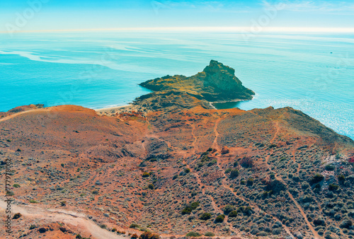 Aerial view of Rocky seashore with clear blue sky. Seascape in the evening. Cabo de Gata-Níjar reserve. Almeria Andalusia Spain