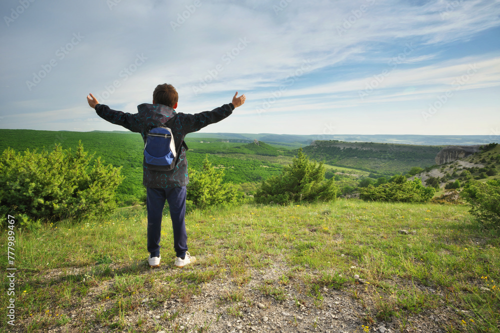 Boy standing and looking at mountainous landscape. Boy standing and looking at mountainous landscape.