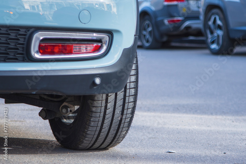 Close-up of car tires and wheel parked on asphalt roads. © GIS