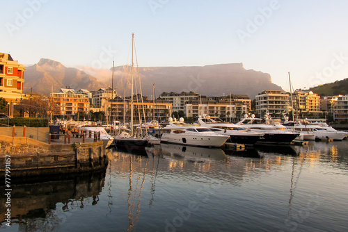 Expensive luxury boats in the marina at the V&A Waterfront, with Table Mountain in the Background, in the late afternoon, Cape Town, South Africa