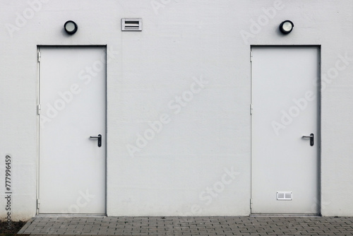 White wall with two closed doors