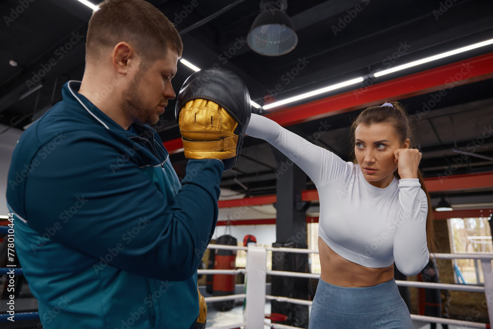 Woman punching to man trainer on taebo training lesson at gym Woman punching to man trainer on taebo training lesson at gym