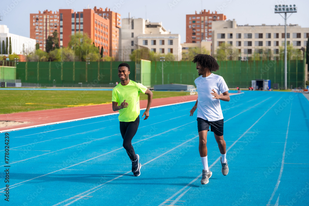 African runners training in an outdoors athletics track African runners training in an outdoors athletics track