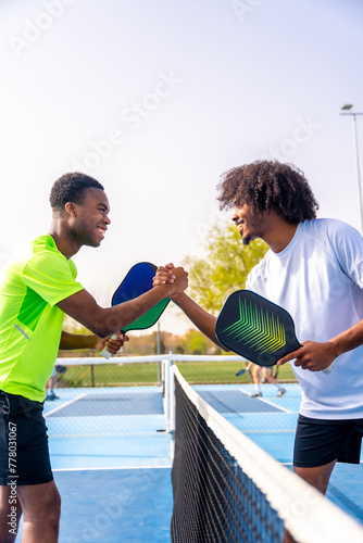 African sportive men shaking hands before playing pickleball