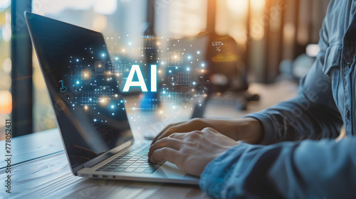 A man working on his laptop with the word AI floating above it