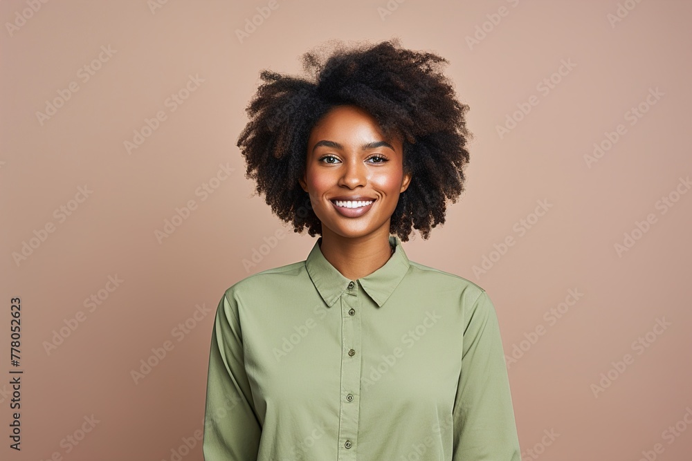 A woman with curly hair is smiling and wearing a green shirt A woman with curly hair is smiling and wearing a green shirt