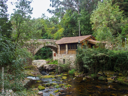 San Xoan de Mourentan Bridge from the 18th century and next to it an old hydraulic sawmill from the 19th century. Arbo, Spain.