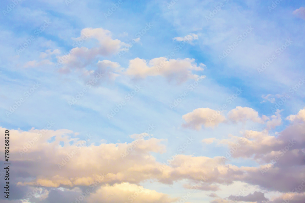 Pastel sunset sky with fluffy clouds, perfect for backgrounds in design and social media
