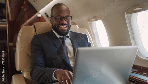 Businessman working on laptop on plane