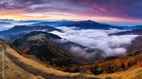 The mountains in fog at night, autumn landscape with alpine mountain valley, low clouds, purple starry sky. Best travel locations. Beautiful scenic