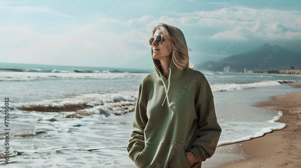 an elderly woman with a green hoodie by the coastline, mock up, perfect for showcasing your designs, branding an elderly woman with a green hoodie by the coastline, mock up, perfect for showcasing your designs, branding