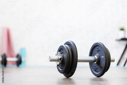 Close-up shot of a dumbbell on the floor that was just left during a workout