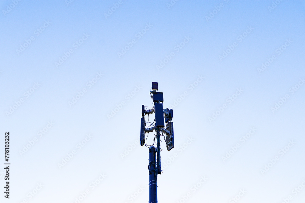 Communication tower telephone pole wireless technology signal future with electric wire tangle. Telecommunication tower of 4G and 5G cellular. Group box Antenna mounted. Sunlight cloud sky background	