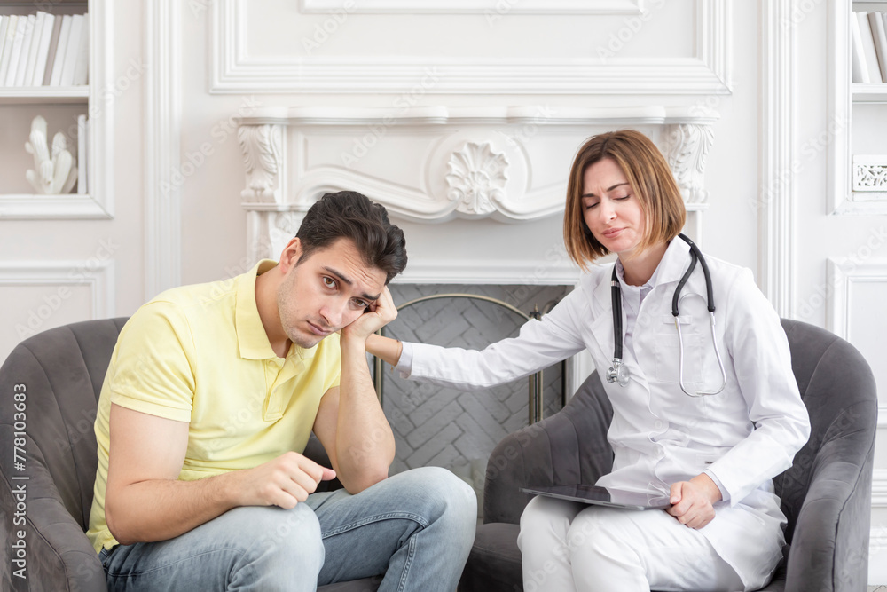 Sad male patient and female doctor discussing about health care problems Sad male patient and female doctor discussing about health care problems