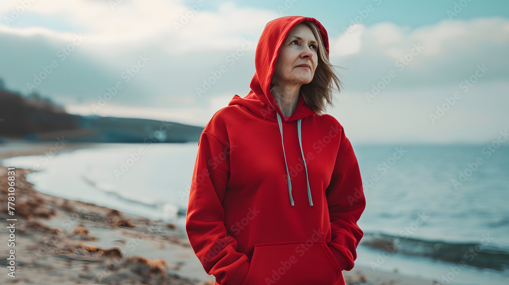 an elderly woman with a red hoodie by the sea, mock up, perfect for showcasing your designs, branding, casual wear an elderly woman with a red hoodie by the sea, mock up, perfect for showcasing your designs, branding, casual wear