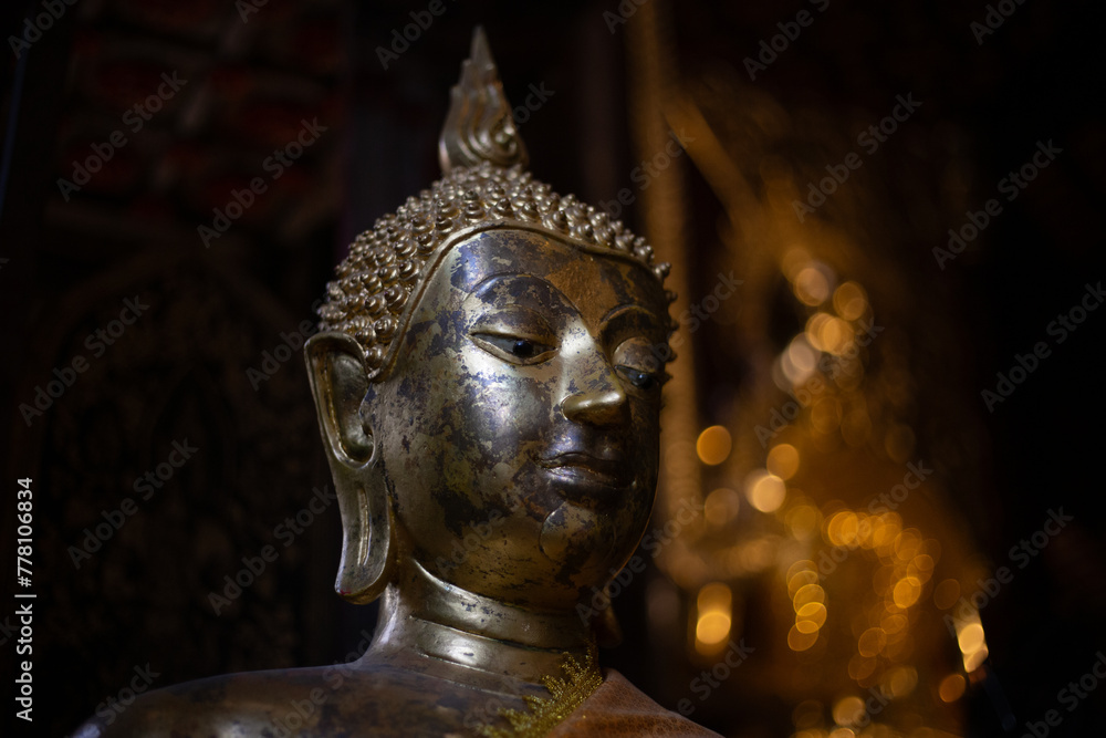 The head of a Buddha statue in an old temple in Chiang Mai, Thailand