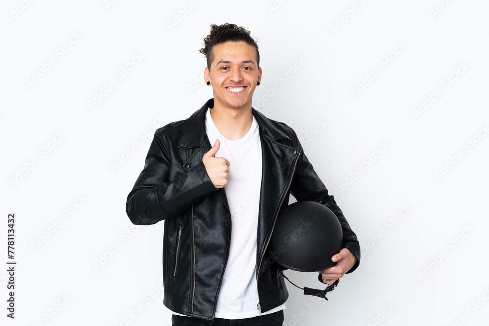Caucasian man with a motorcycle helmet over isolated white background giving a thumbs up gesture Caucasian man with a motorcycle helmet over isolated white background giving a thumbs up gesture