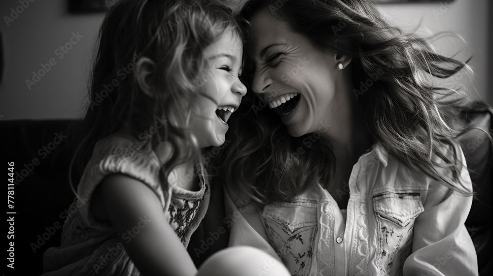 Mother and daughter having fun laughing on the sofa Mother and daughter having fun laughing on the sofa