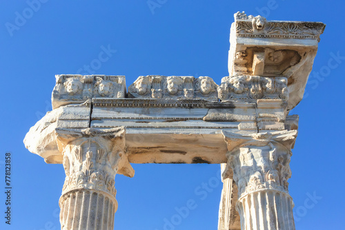 Murais de parede Detailed view of the ornate mask frieze on Apollo Temple in Side, set against a clear blue sky