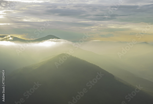 the fog glows in the evening in the mountains