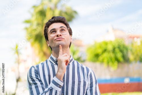 Young handsome man With glasses and looking up