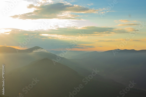  sunset in the mountains, evening mist drifts into the valleys, watercolor sky, sunlight dissolves in the evening mist