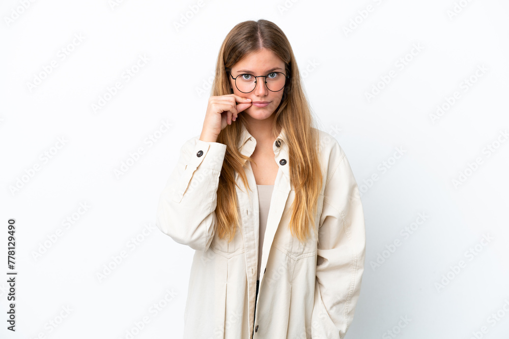 Young blonde woman isolated on white background showing a sign of silence gesture Young blonde woman isolated on white background showing a sign of silence gesture