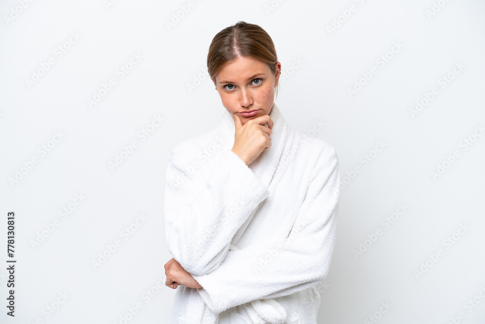 Young pretty blonde woman in bathrobe isolated on white background thinking Young pretty blonde woman in bathrobe isolated on white background thinking