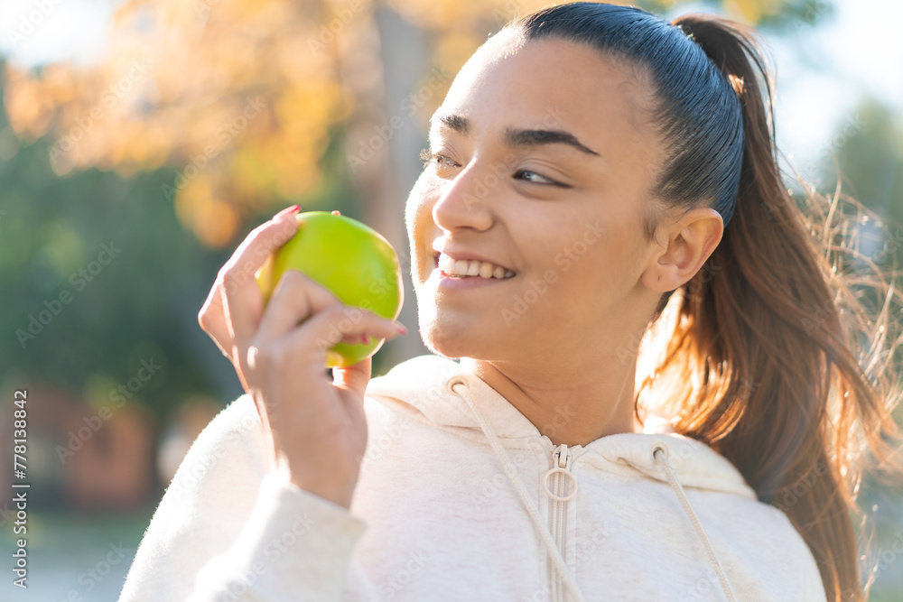 Young pretty sport woman holding an apple with happy expression Young pretty sport woman holding an apple with happy expression