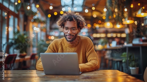 Man Using Laptop at Table