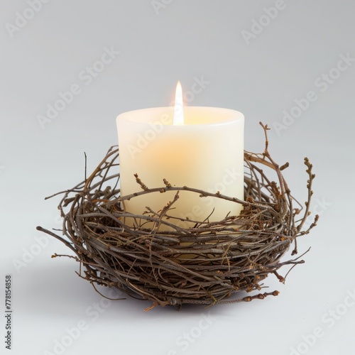candle in a nest of branches with fog.