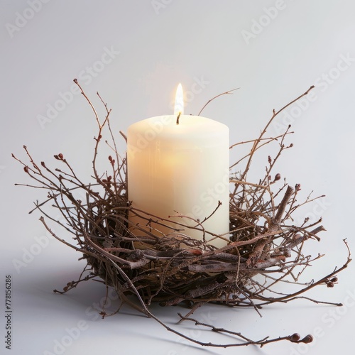 candle in a nest of branches with fog.