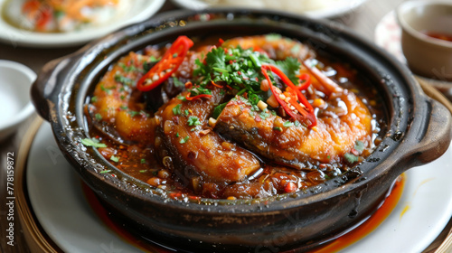 Vietnamese caramelized fish in clay pot photo