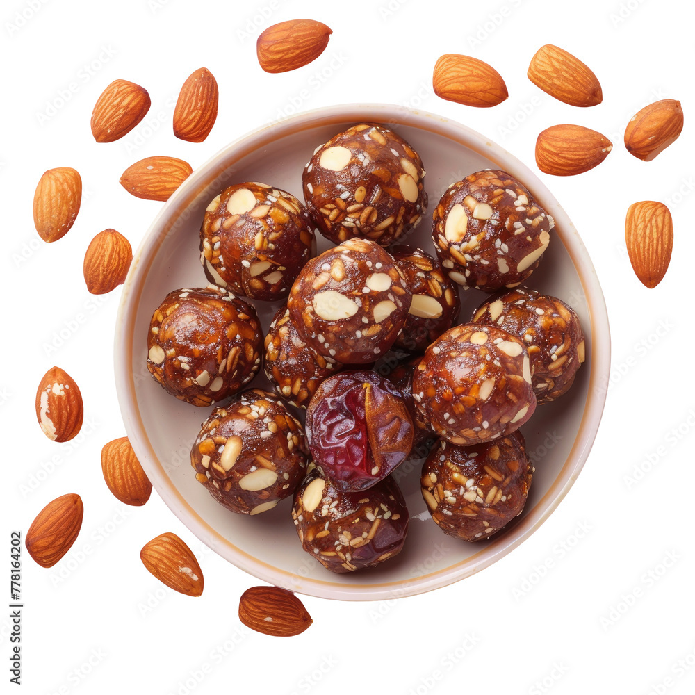 A bowl of assorted nuts and dates on a wooden table A bowl of assorted nuts and dates on a wooden table