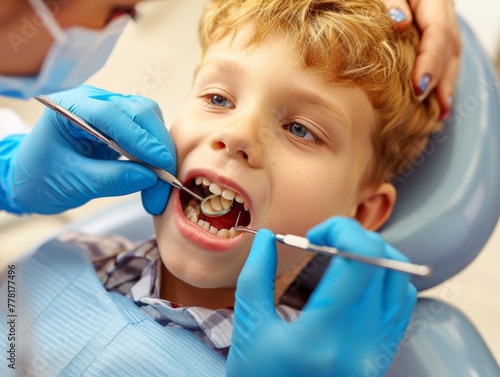The child is lying in the dental chair and the doctor is examining and treating his teeth