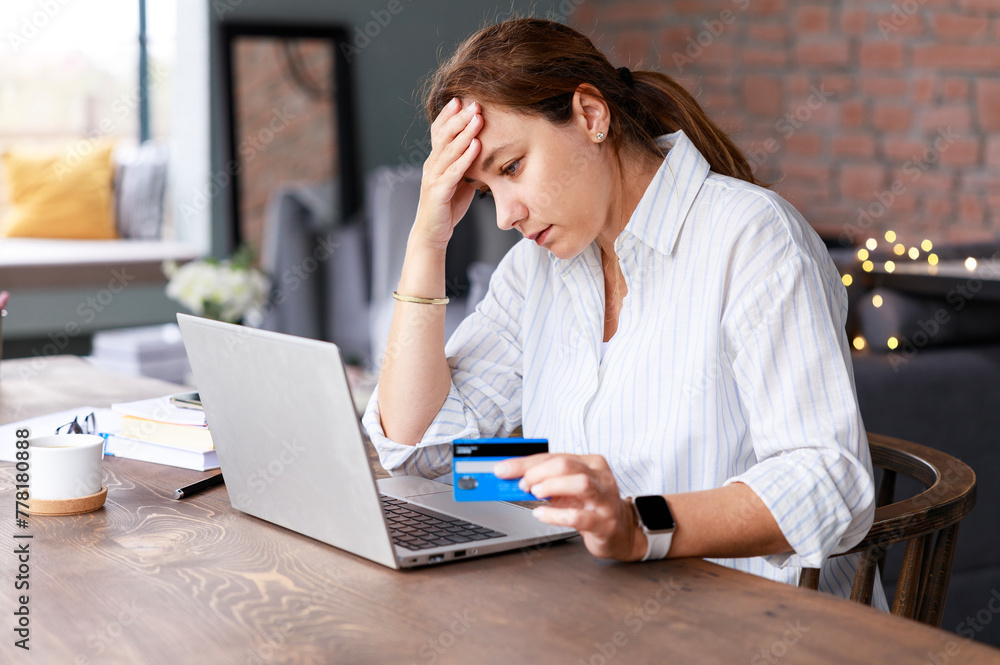 Young woman have problems with her credit card during shopping online Young woman have problems with her credit card during shopping online