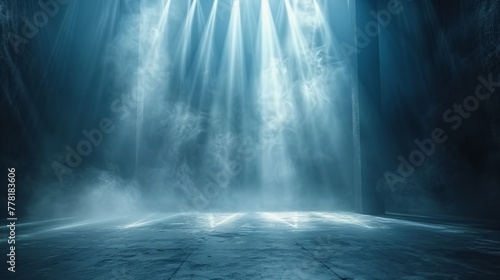 Intense beams cut through mist on an empty stage.