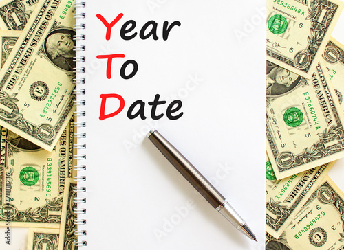 YTD year to date symbol. Concept words YTD year to date on beautiful white note. Dollar bills. Beautiful dollar bills background. Business YTD year to date concept. Copy space. photo