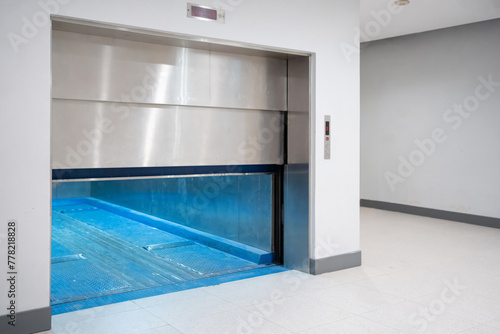 Modern freight elevator featuring a sleek two-section slide-up door design