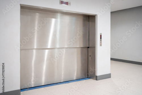 Modern freight elevator featuring a sleek two-section slide-up door design