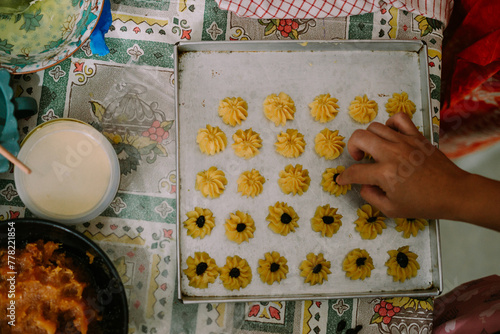 A syringe cake in the shape of a flower and filled with jam or raisins in the middle. Semprit cake is an Eid cake. photo