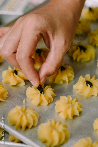 A syringe cake in the shape of a flower and filled with jam or raisins in the middle. Semprit cake is an Eid cake. photo