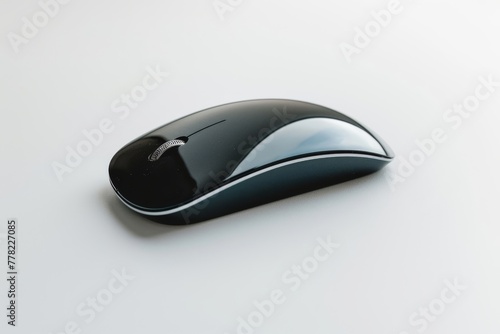 Modern black wireless computer mouse on a minimalist white desk