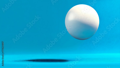 Minimalist white ball floating above a blue surface, suited for clean design concepts and modern art illustrations.